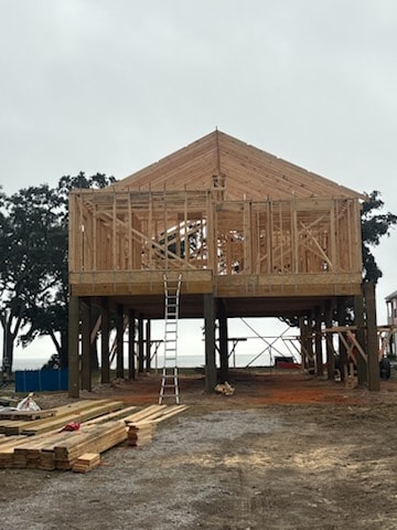 Piling home framing with roof trusses