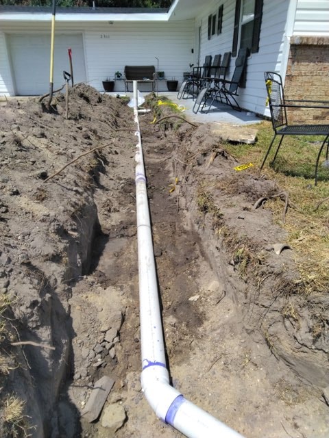 Rovira plumber working on pipe repair inside home