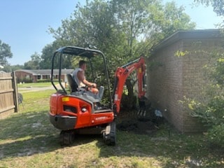 Mini excavator used for sewer line work